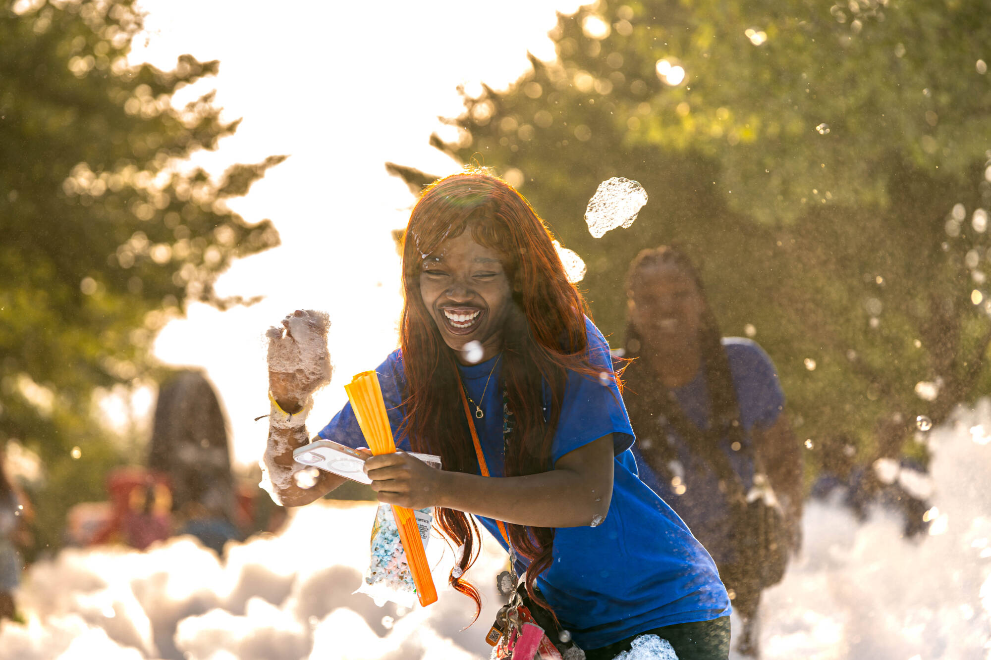 A student dancing in the foam pit at Laker Kickoff
